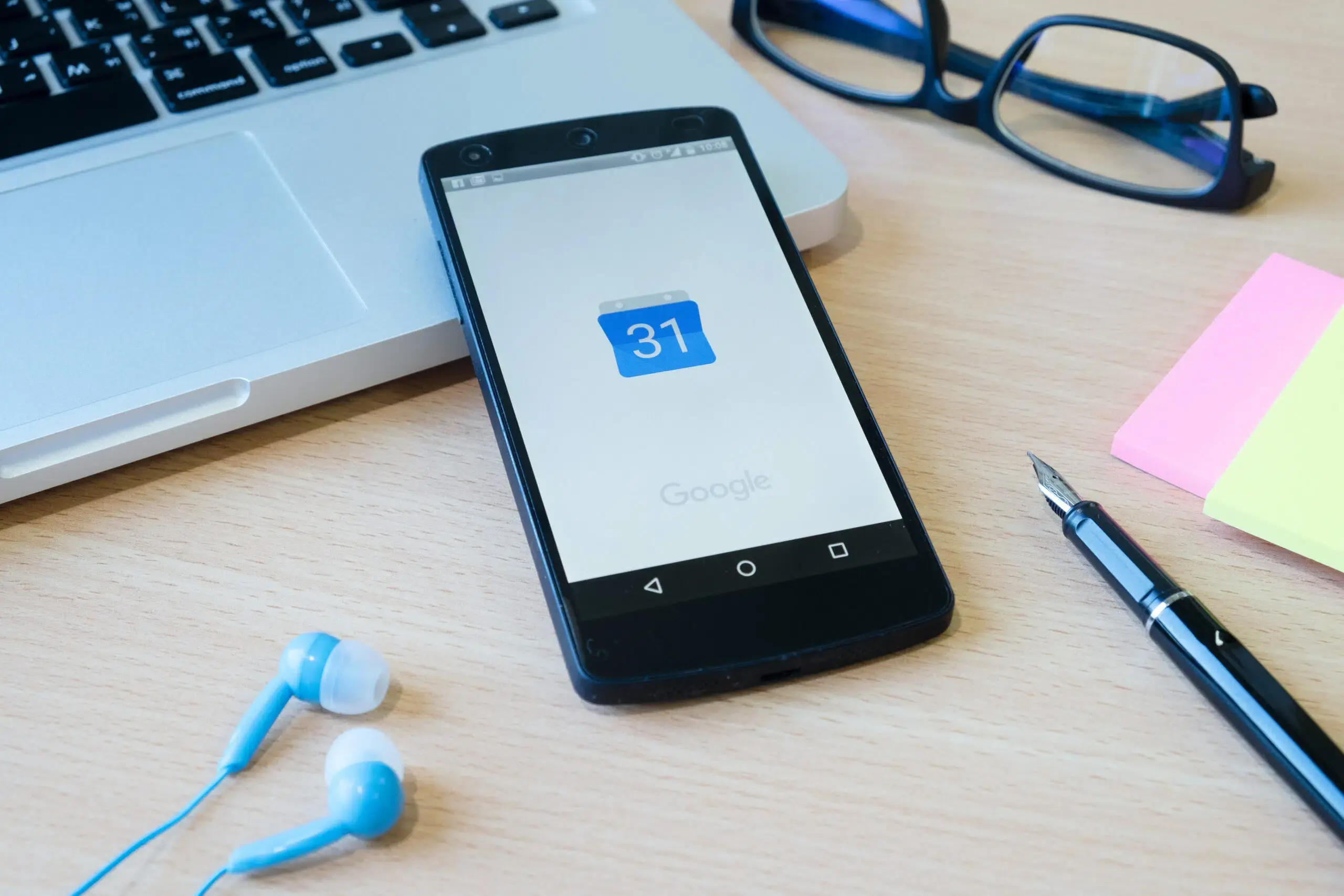 A cell phone on a desk opening an editorial calendar