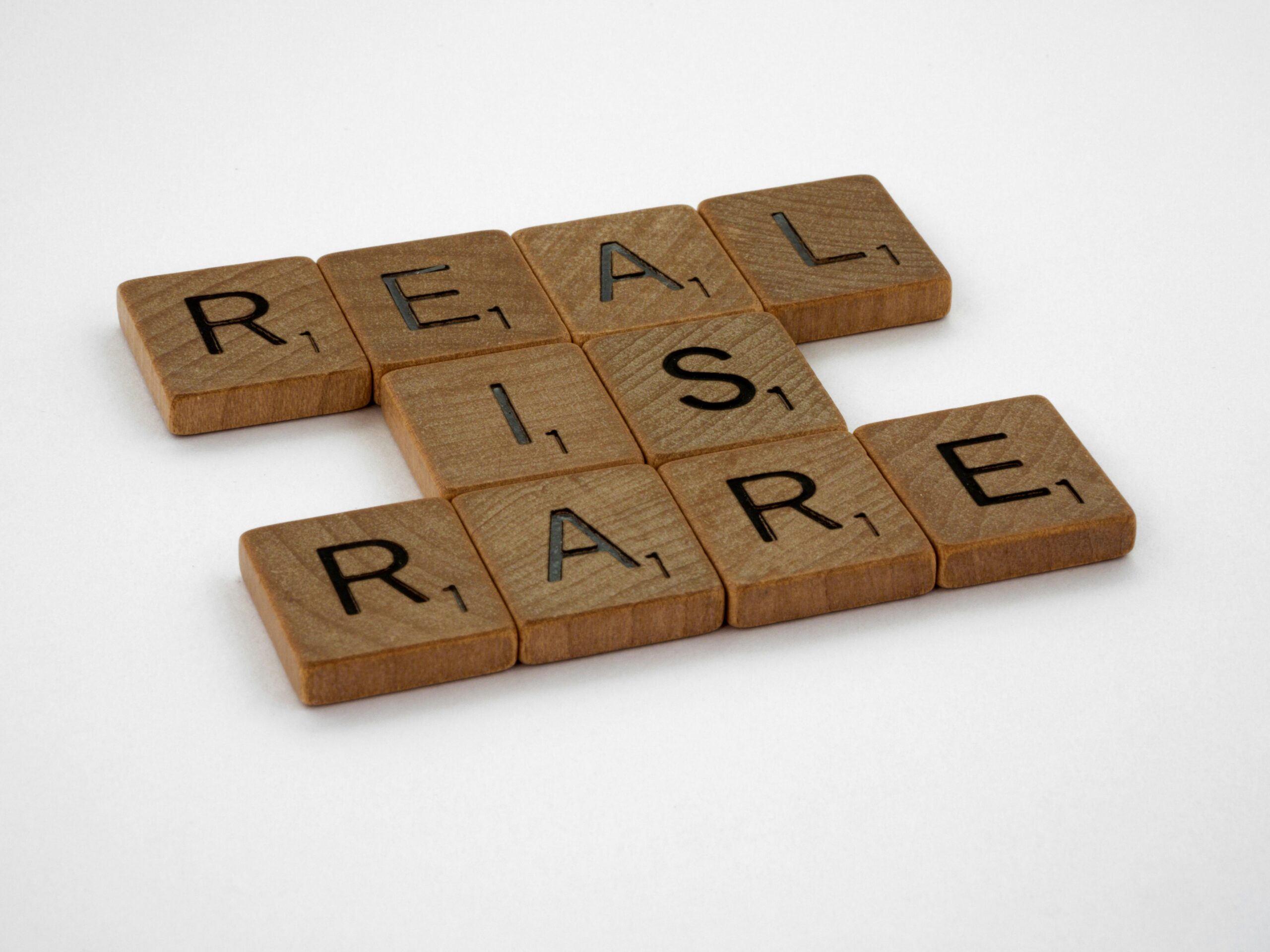 Why authenticity is your best AI strategy 1 Photograph of a series of Scrabble tiles, spelling out "real is rare."