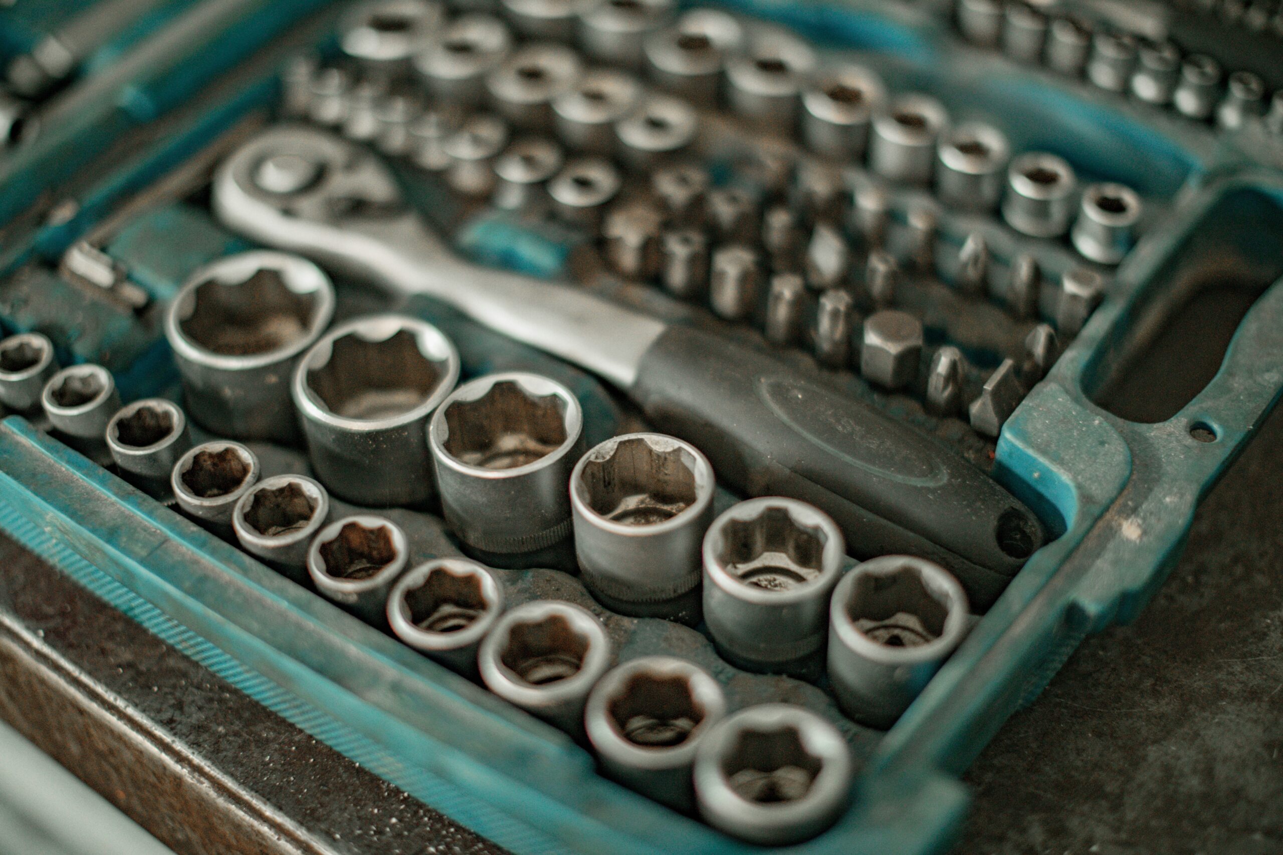 AI strategy isn’t about tools. It’s about culture shift. 1 Photograph of a turquoise toolbox that contains a socket wrench and sockets.