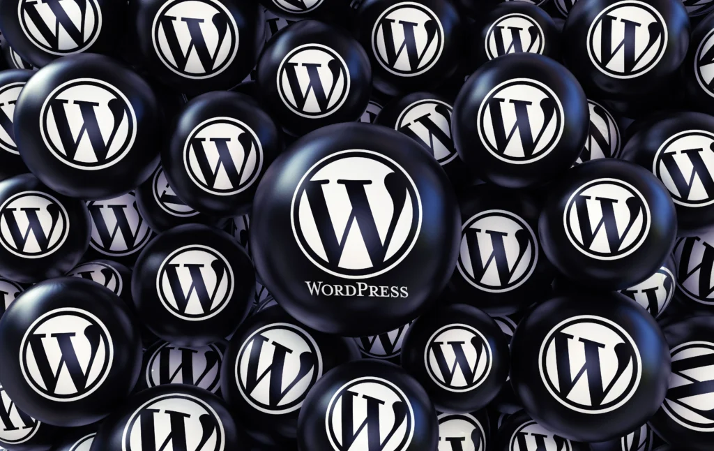 Beware of risky AI website building practices 2 Multiple black spheres featuring the WordPress ‘W’ logo clustered together, creating a repeating WordPress branding pattern.