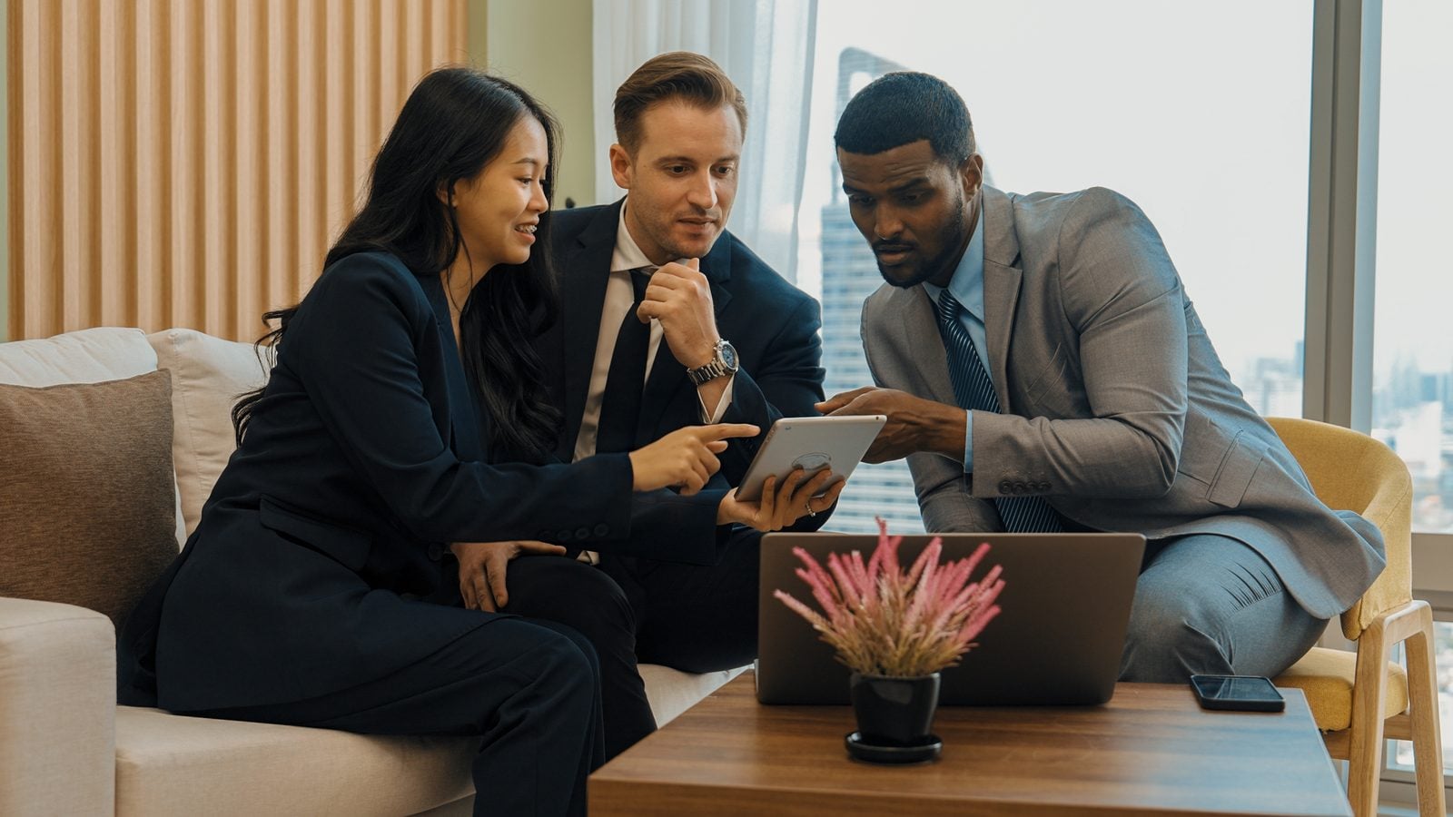 A 41% Increase in Yearly Signed Cases: How Agentic Marketing Helps Crosley Law Rise in Visibility 3 Three professionals reviewing results on a tablet together in a modern office